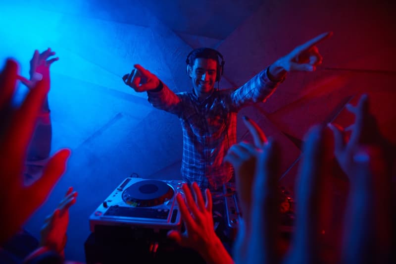 A DJ performing for a dancing crowd