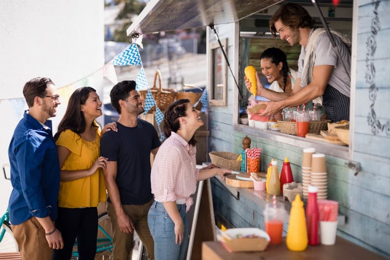 Guests talking with a food truck vendor